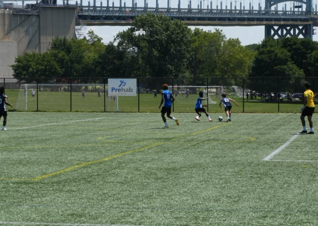 Youth playing soccer on field